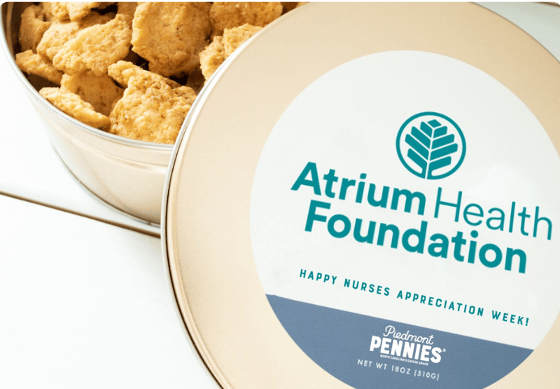 Corporate Gifting Gold Tin with customized Atrium Health Logo